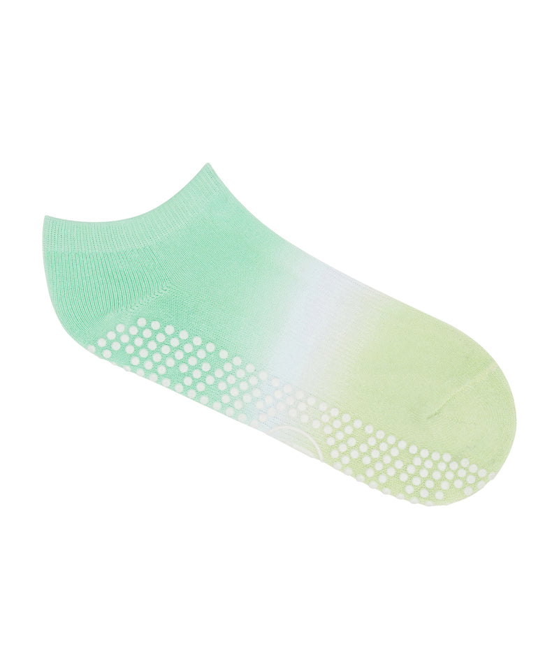 Pair of Classic Low Rise Grip Socks in Miami Green Ombre on a wooden floor