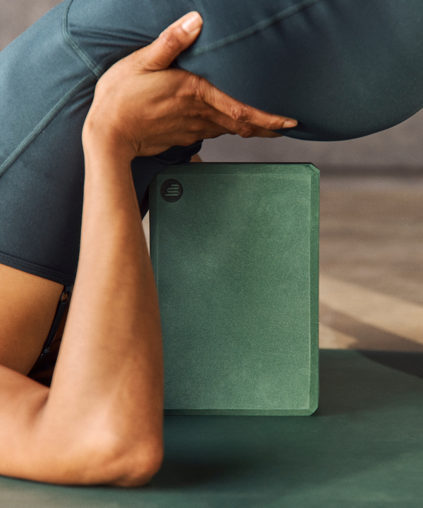  Close-up of a khaki yoga block made from high-density foam for providing support and balance