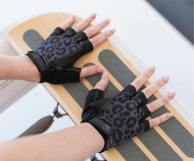 Stylish and functional Pilates grip gloves in black with cheetah design