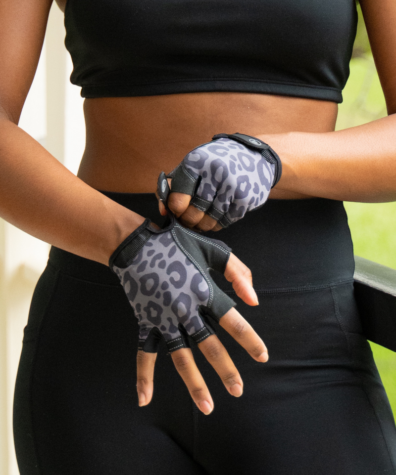 Close-up of black Pilates grip gloves with textured palm for better grip